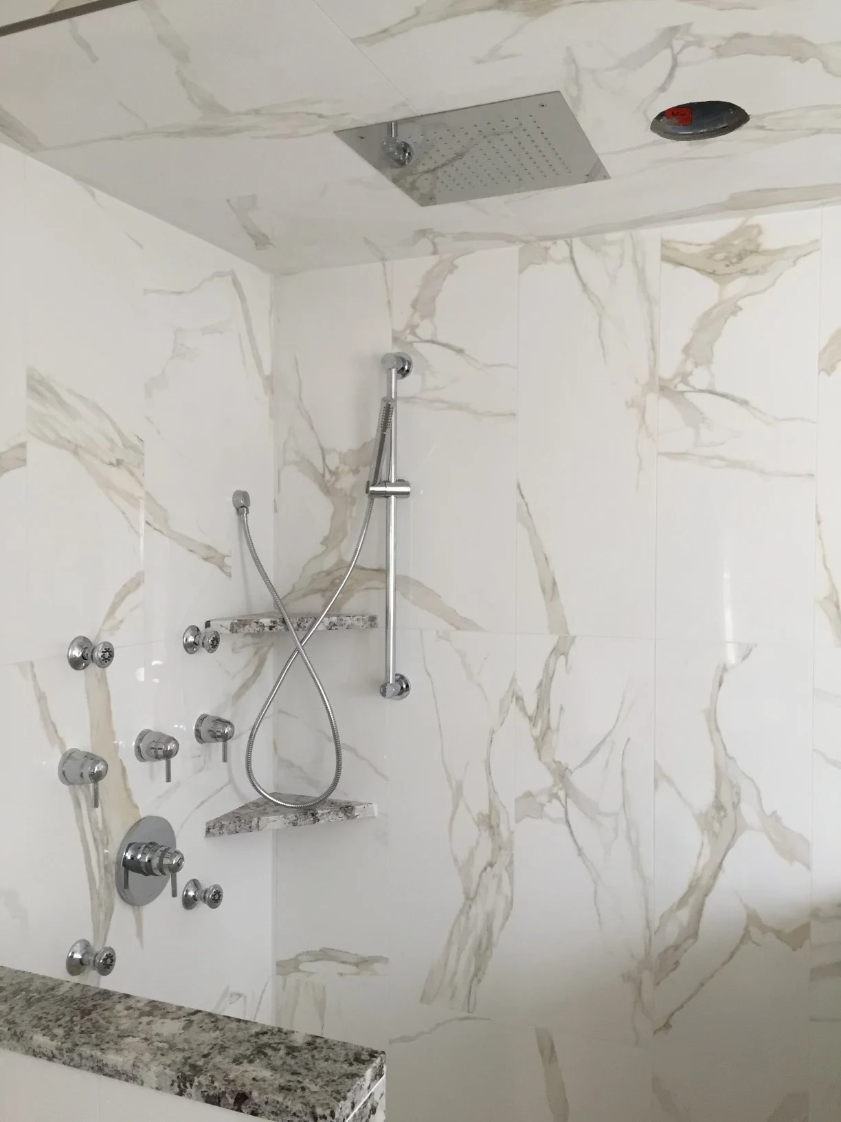 Marble shower with rainfall head, handheld shower and body jets installed by Apex Plumbing